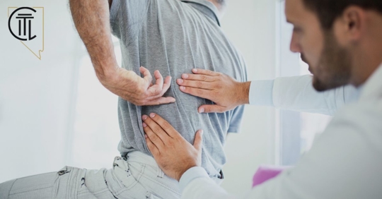 doctor assessing patients back