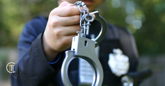 officer holding handcuffs